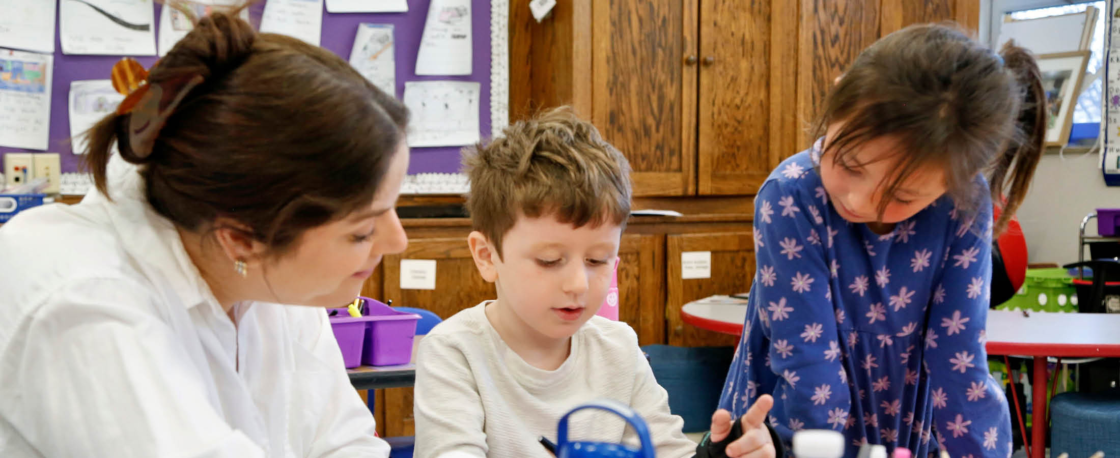 Students working with teacher