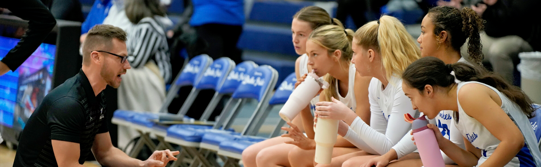 Girls Cross Country team in a huddle