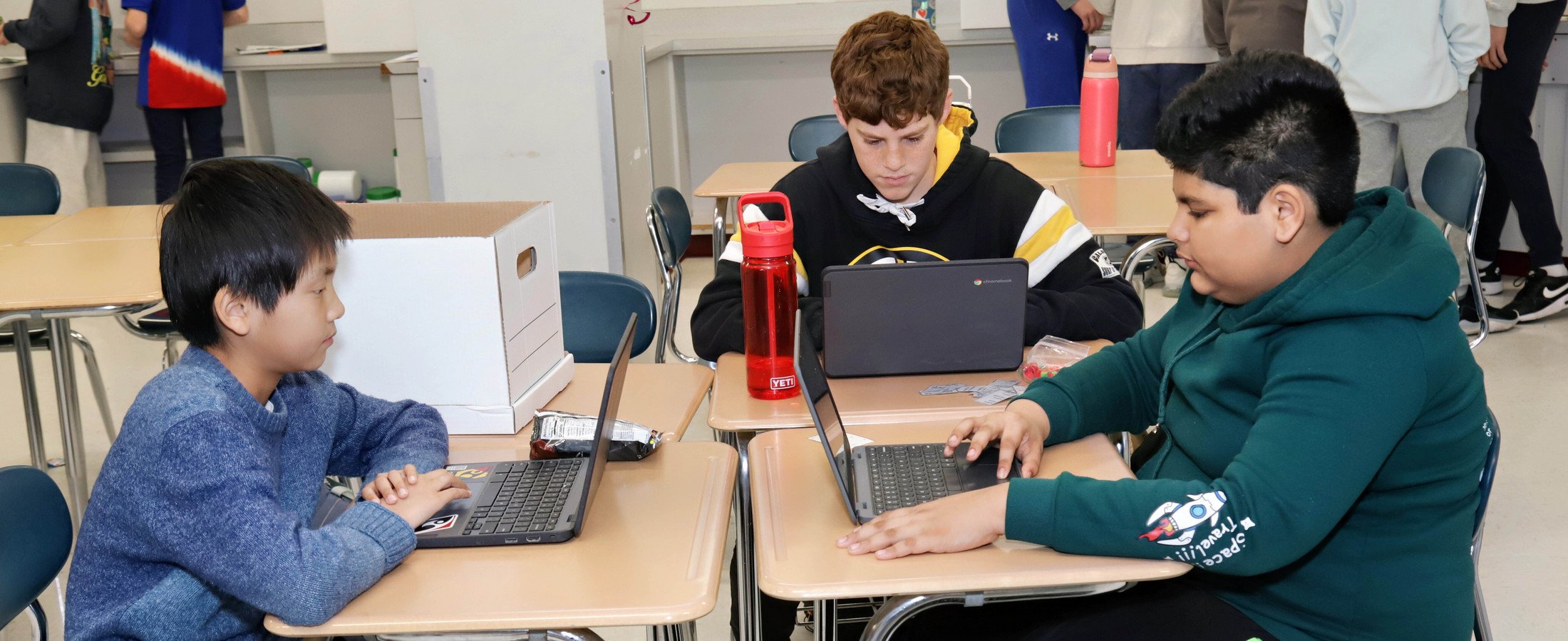 Three learners at desks