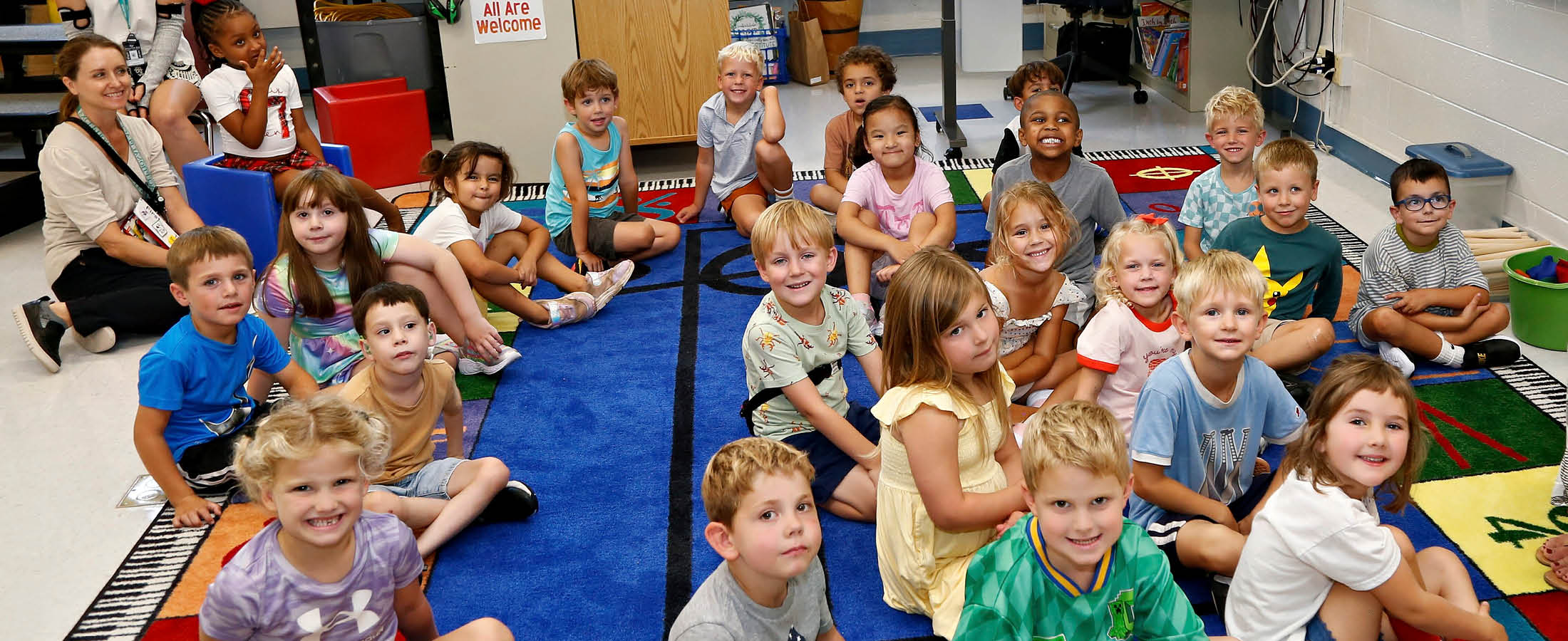 Students sitting on rug