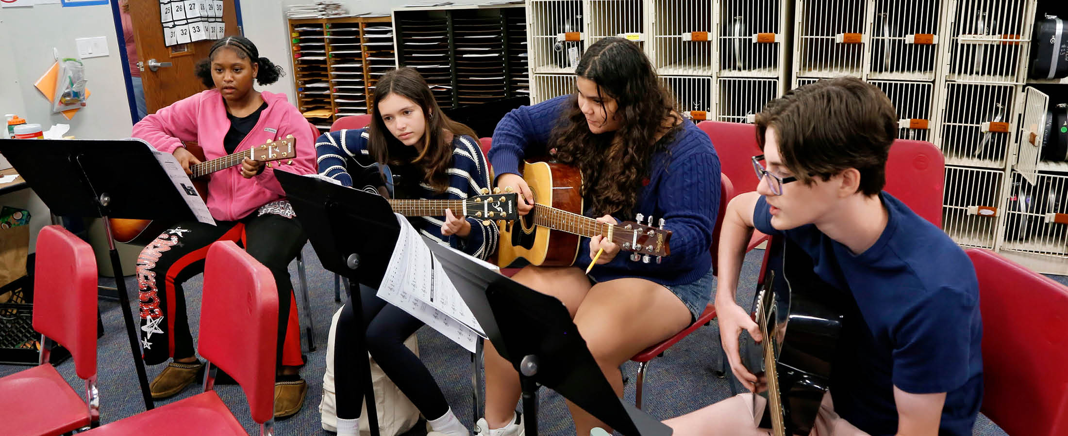 Middle School students playing guitar