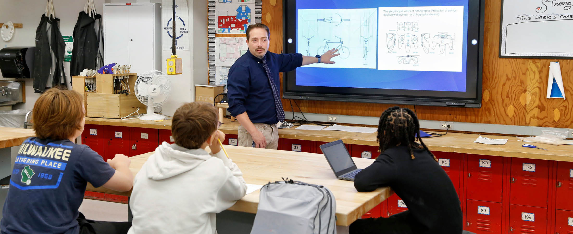 Teacher pointing at smartboard