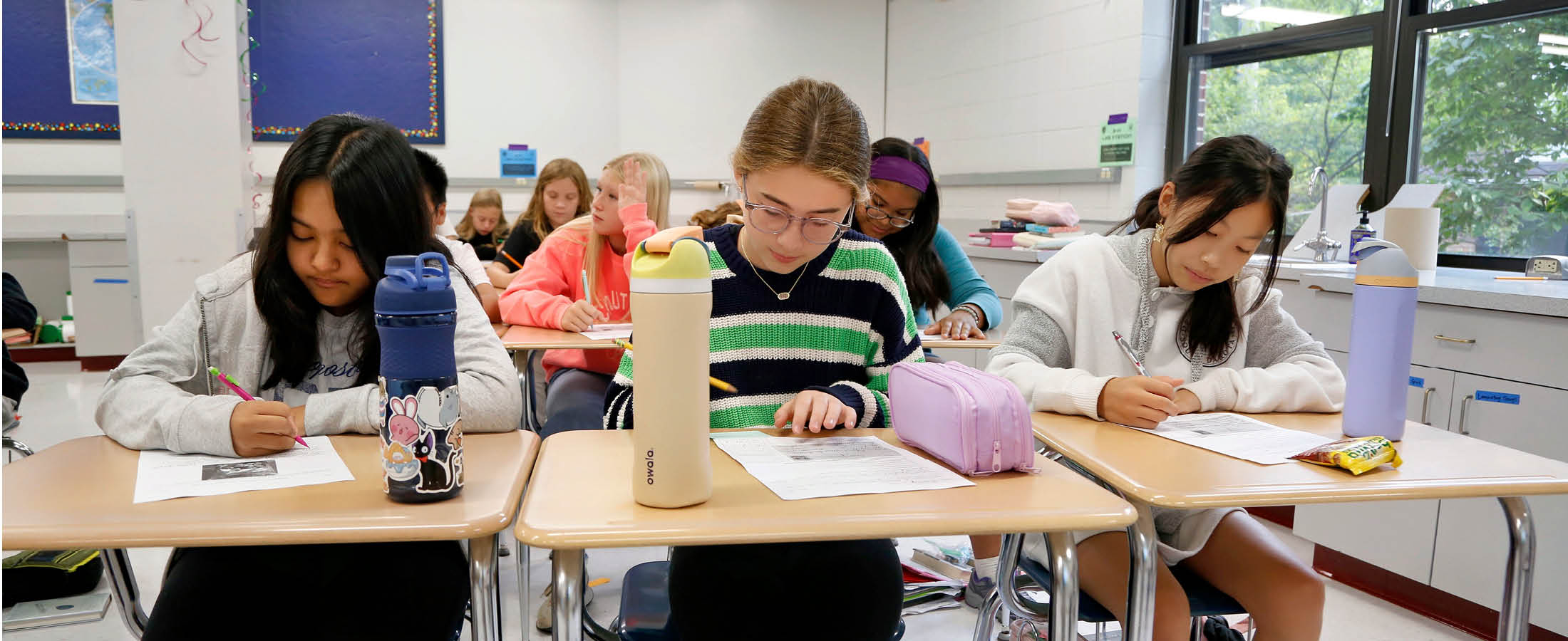Students writing at desks