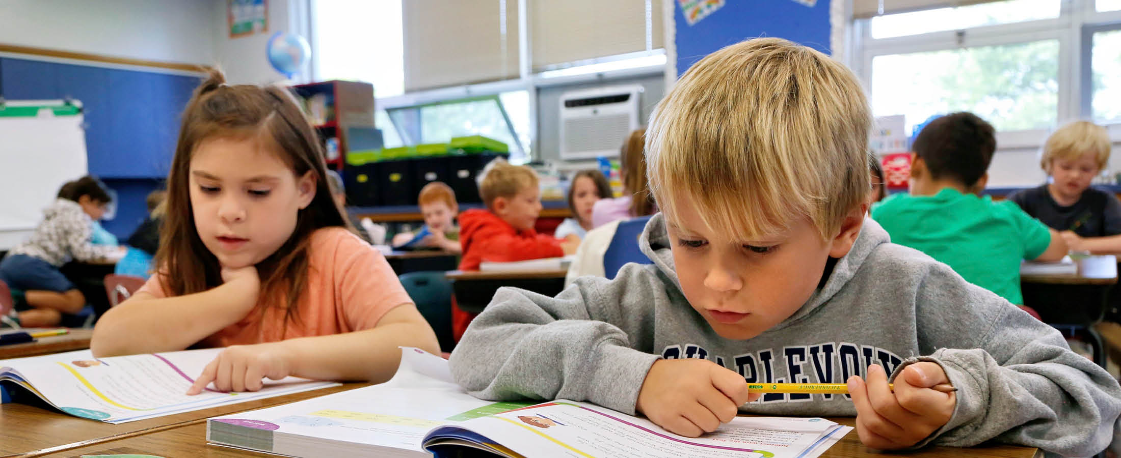 Two students reading at desks