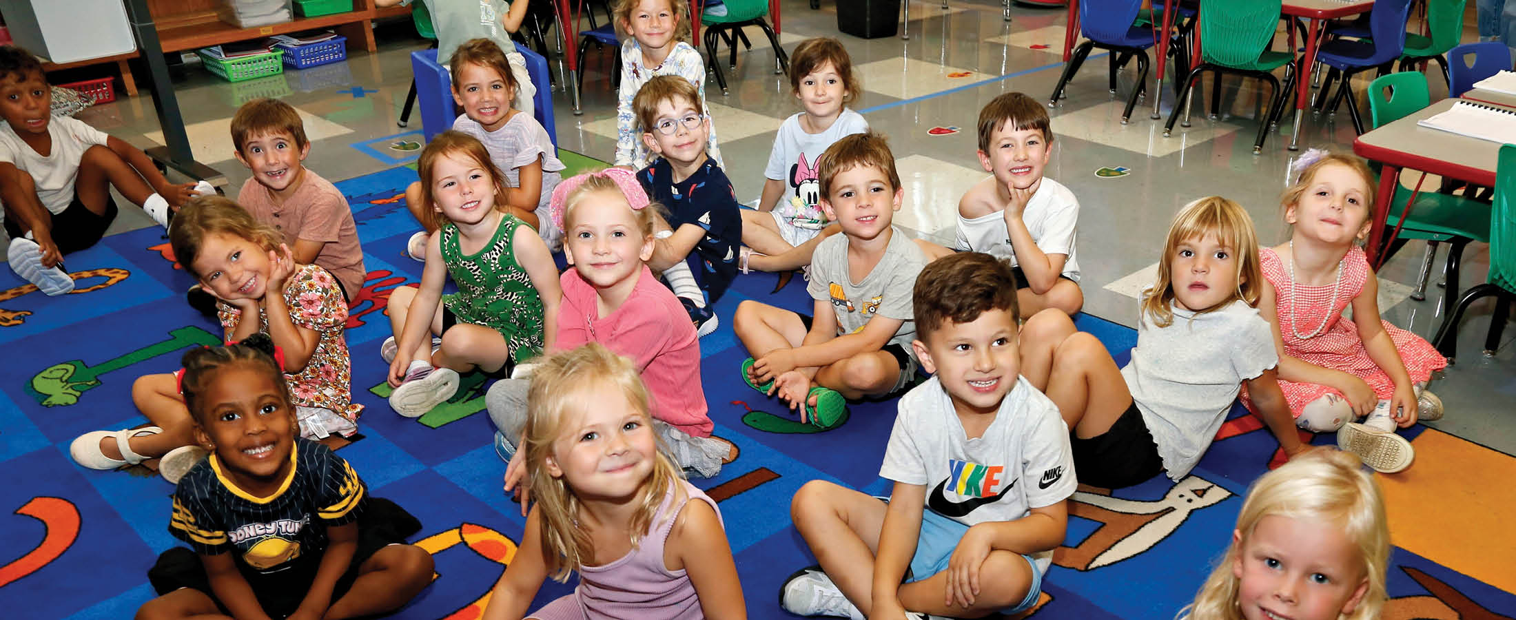 Students sitting on a rug