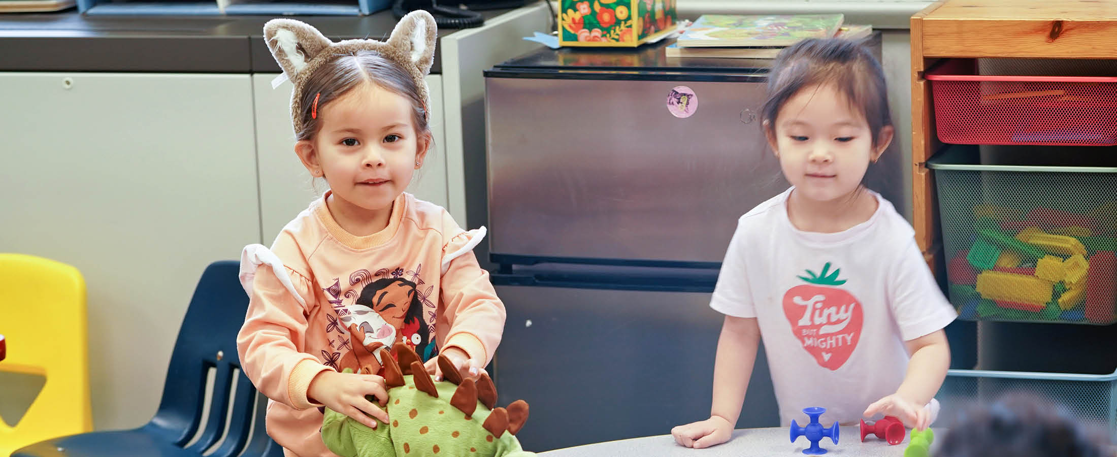 Students playing with dinosaurs