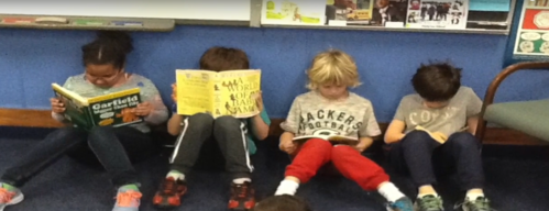 four students reading