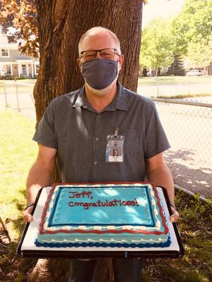 Teacher holding a celebration cake