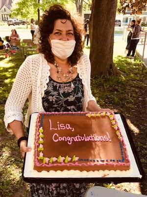 Teacher holding a celebration cake