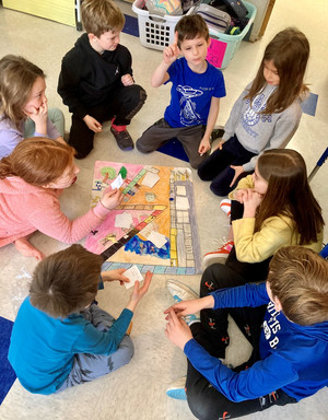 4th grade students playing a board game